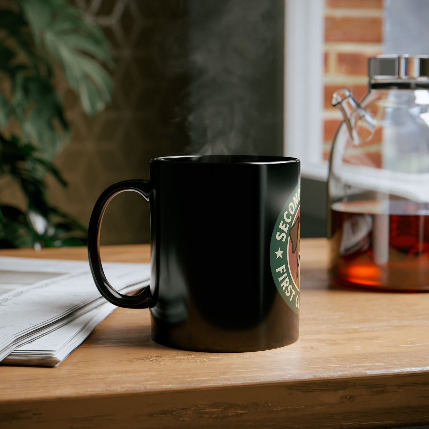 Black Starbucks mug on a wooden table with a blurred background