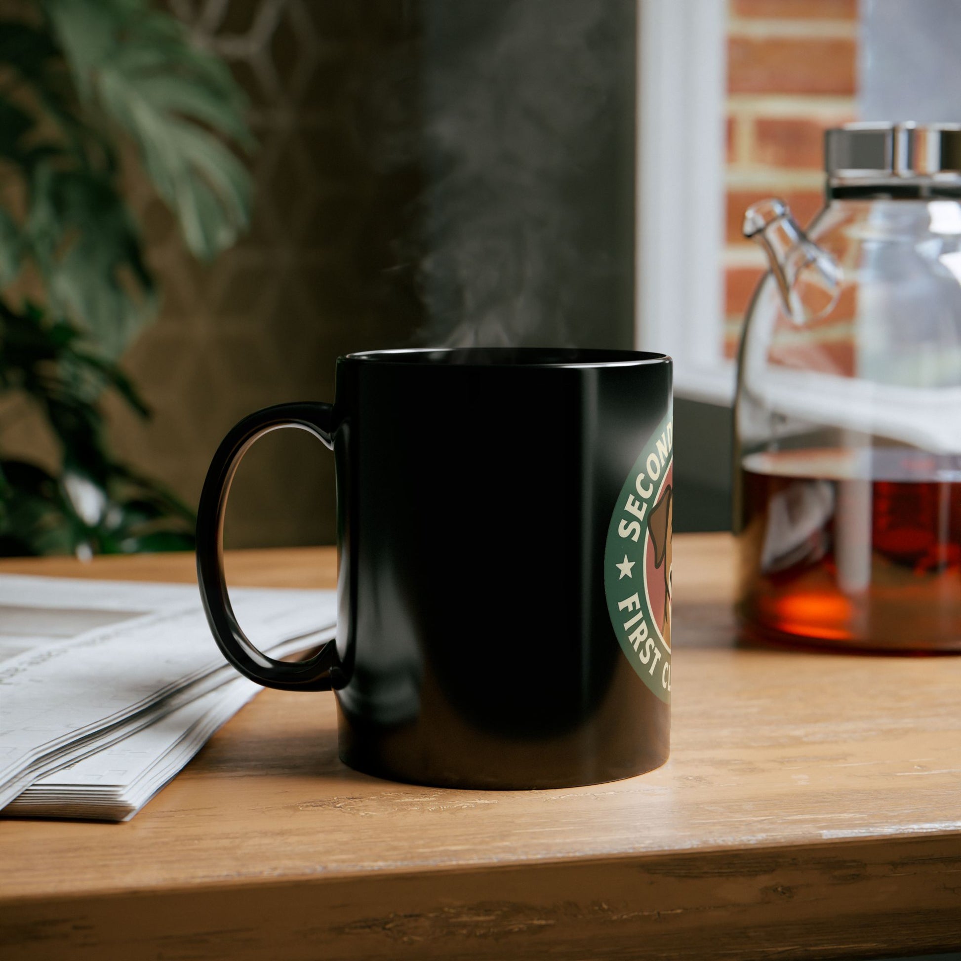 Black Starbucks mug on a wooden table with a blurred background