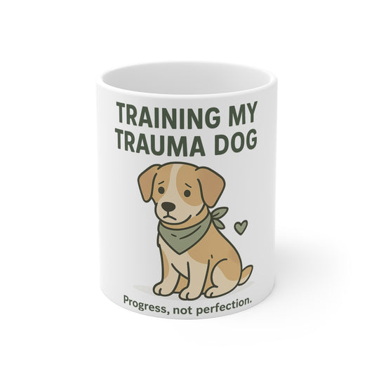 White mug with a cartoon dog and text 'Training my trauma dog' on a white background
